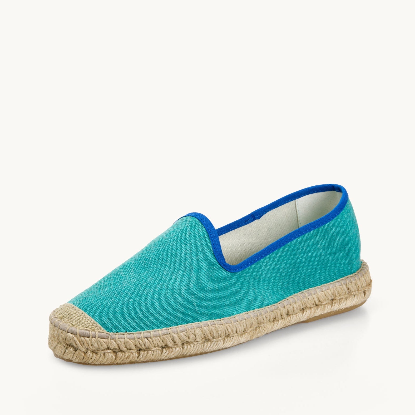 One men's green cotton canvas loafer. Jute sole and detail on the toe. Neck opening of the espadrille has a narrow ribbon edged in royal blue. Inside of the footwear is white.