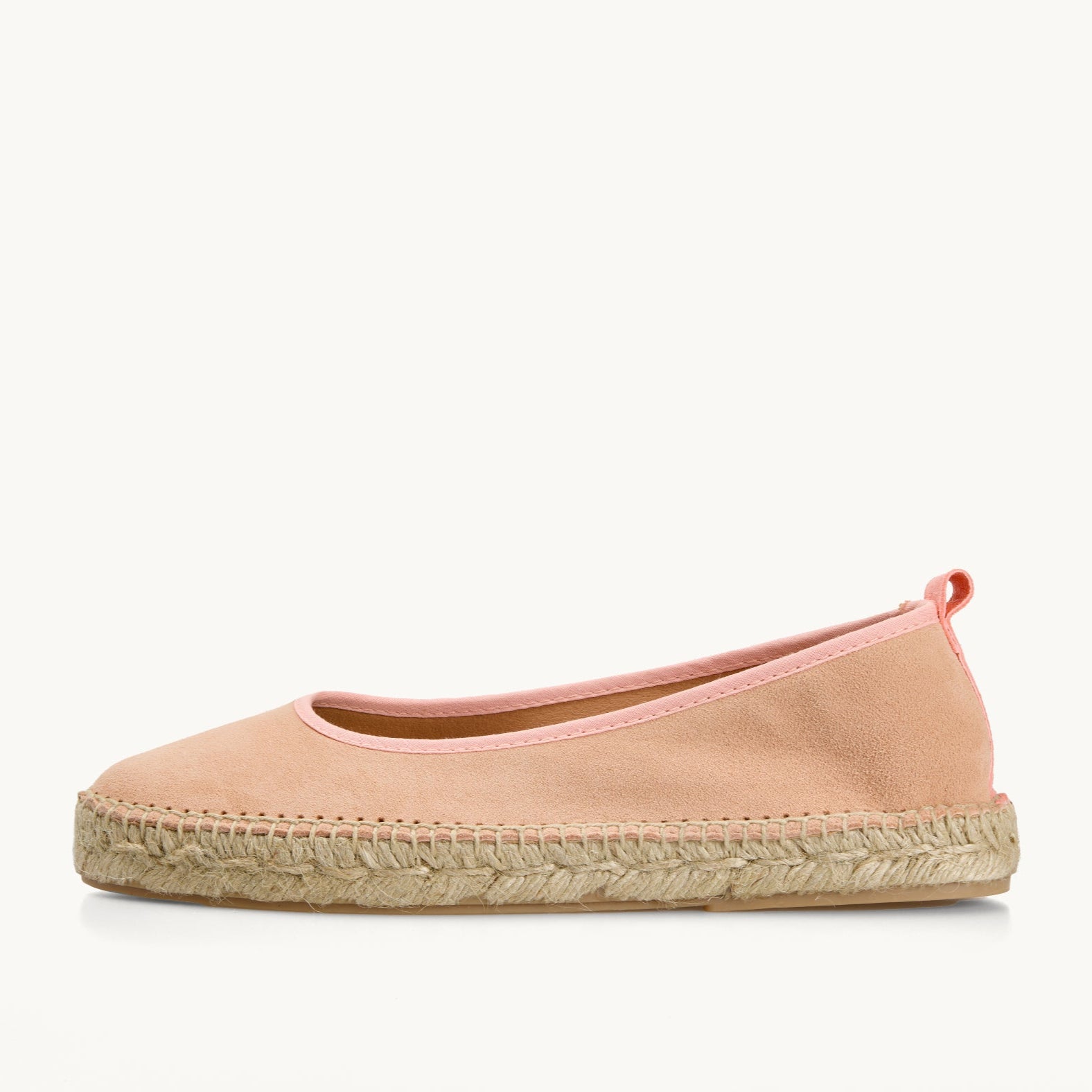 One women's ballet espadrille flat shoe. Peach suede with matching trim around the opening of the shoe with stitching around the edge joining the upper to the a traditional jute sole.