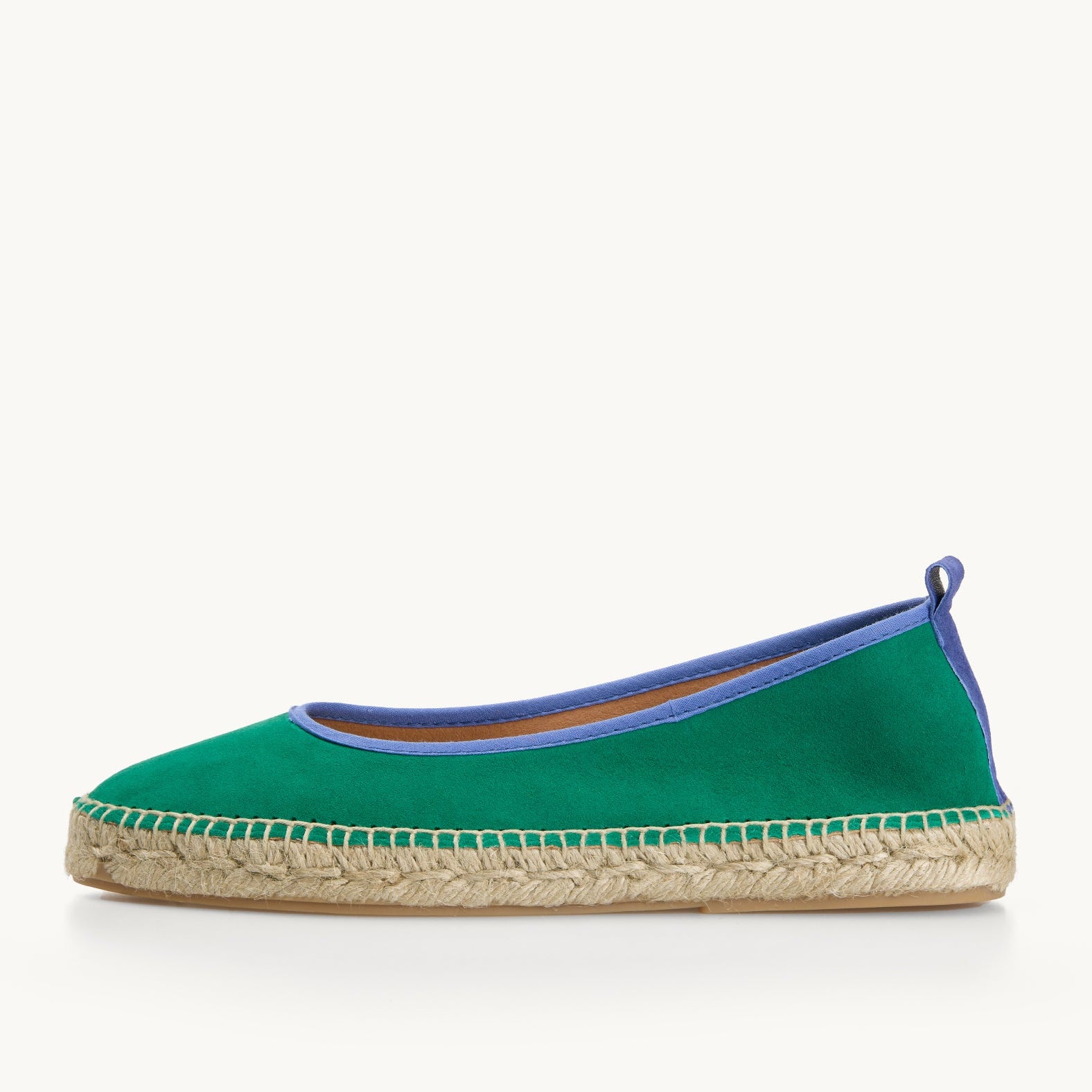 One women's ballet espadrille flat shoe. Green suede with blue trim around the opening of the shoe with stitching around the edge joining the upper to the a traditional jute sole.
