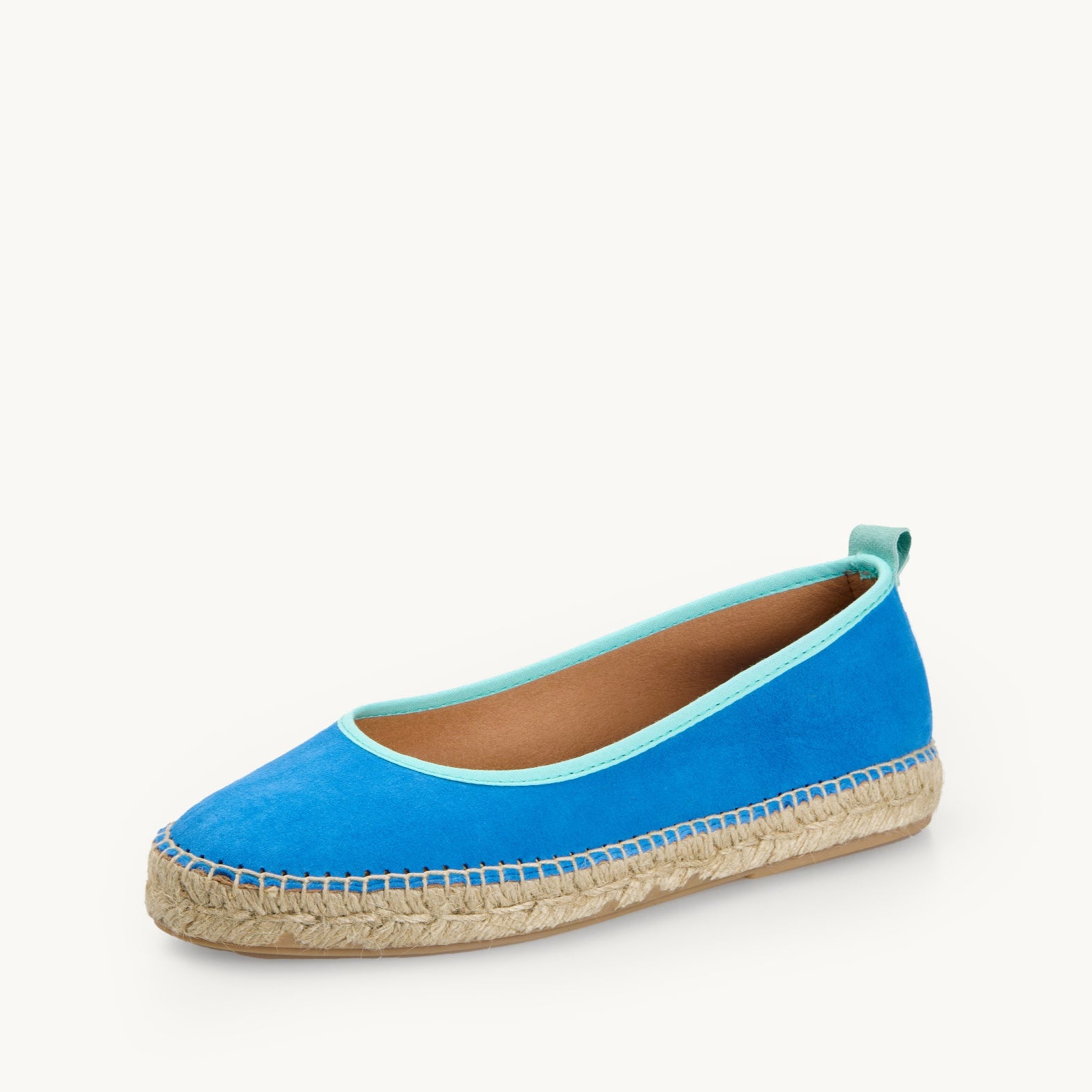 One ballet flat espadrille in Azure blue suede with duck egg, light turquoise trim around the opening of the shoe with stitching around the edge joining the upper to the a traditional jute sole.