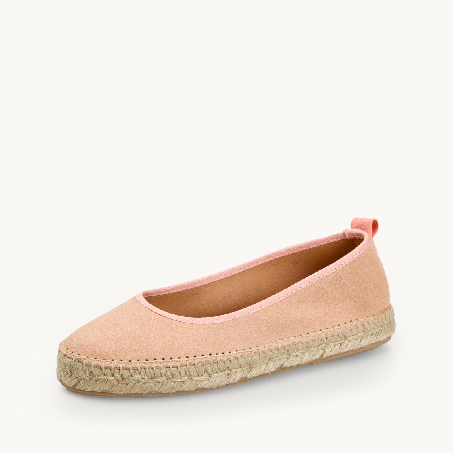 One women's ballet espadrille, flat shoe. Peach suede with matching trim around the opening with stitching around the edge joining the top to the a traditional jute sole.